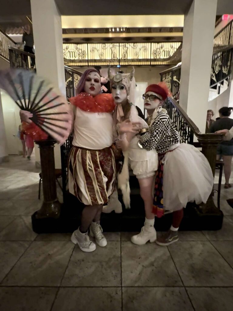 Three City of Fountains Sisters in clown-themed looks at a concert, August 2026